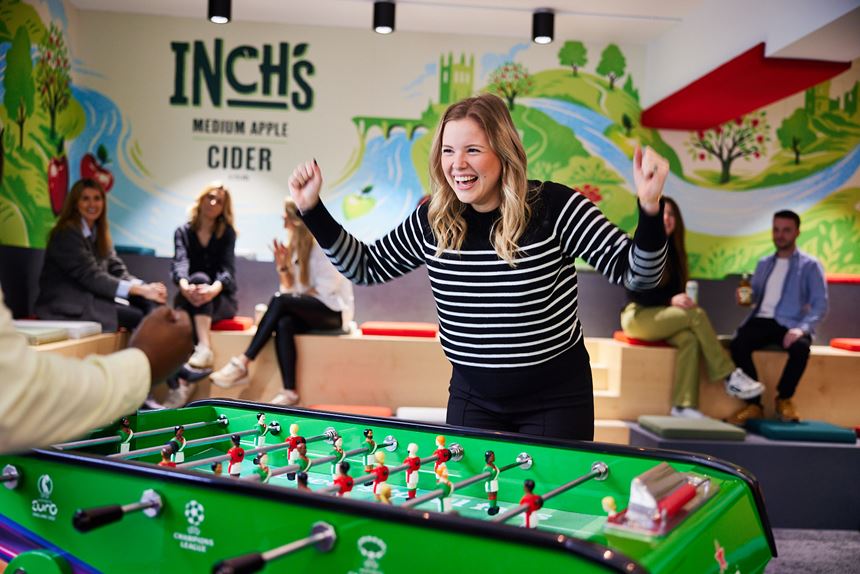 Colleague playing table football