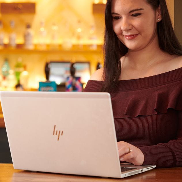 Photo of colleague in the pub on laptop
