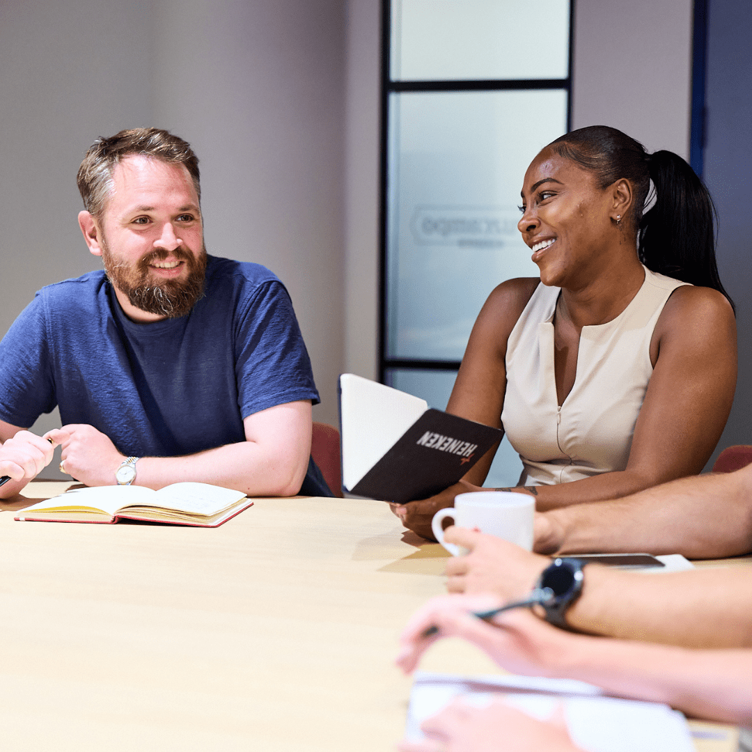 Two colleagues having a conversation in a meeting